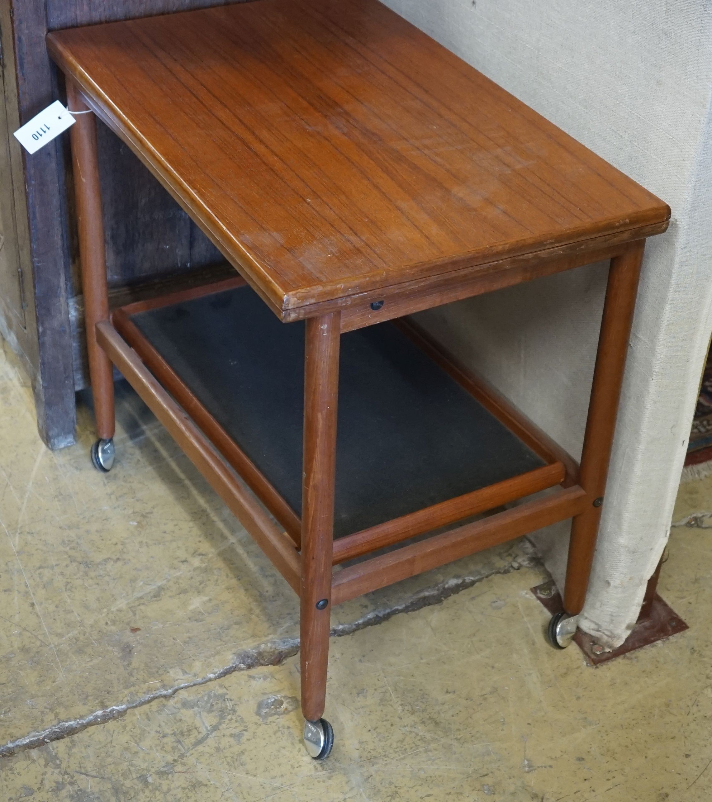 A Danish teak two tier tea trolley with folding top, width 70cm, depth 44cm, height 65cm